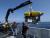 The ROV Hercules with Kraft Predator arm being launched over the side of the NOAA research vessel Ronald Brown.